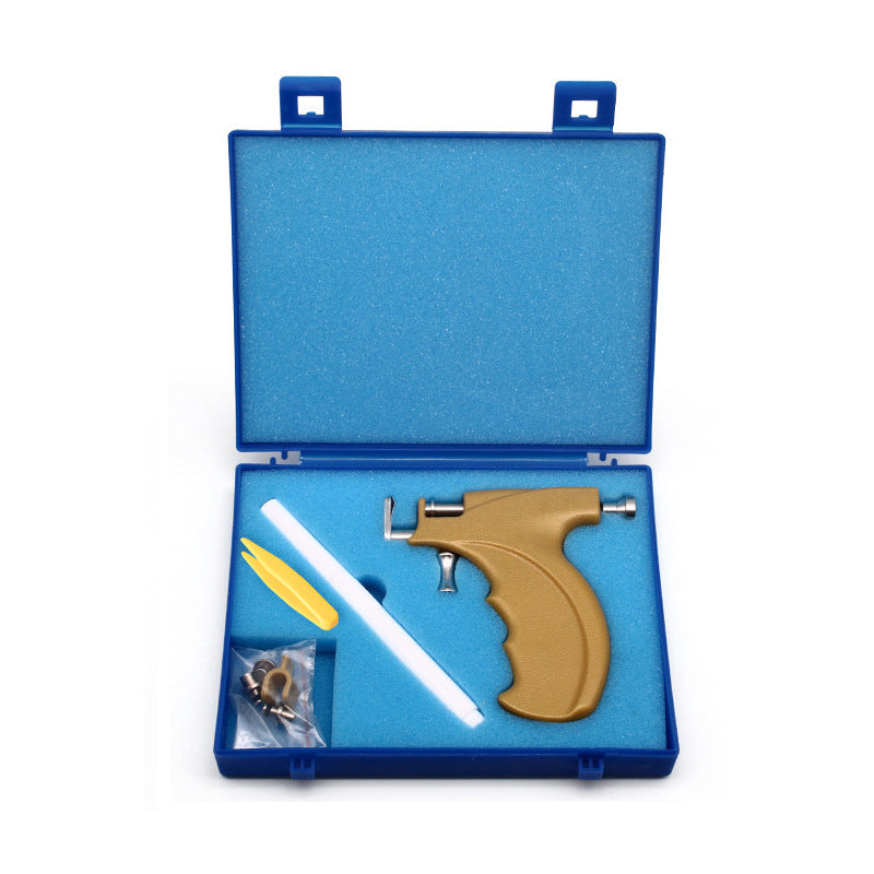 Pistolet à piercing pour oreilles avec clous en acier inoxydable.