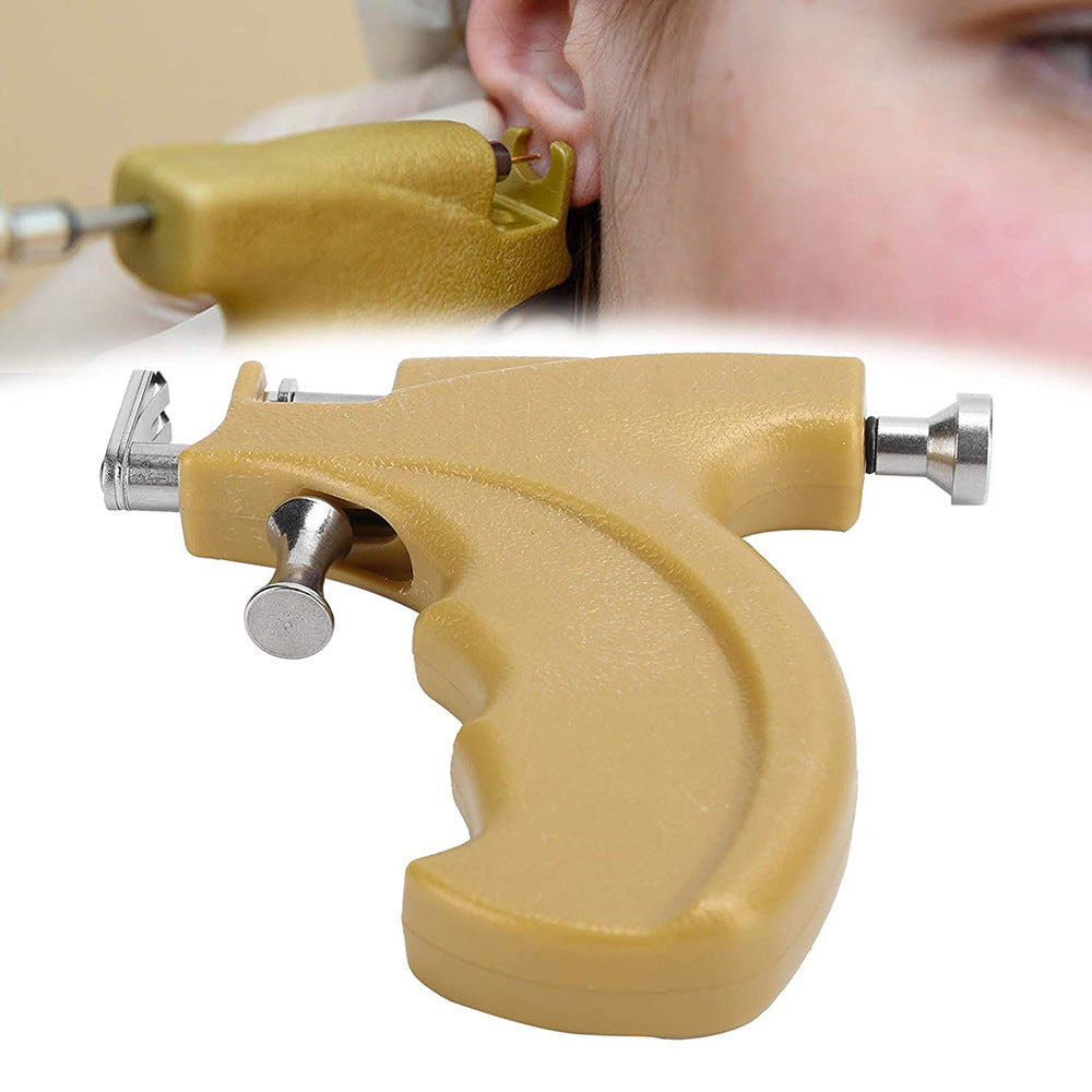 Pistolet à piercing pour oreilles avec clous en acier inoxydable.
